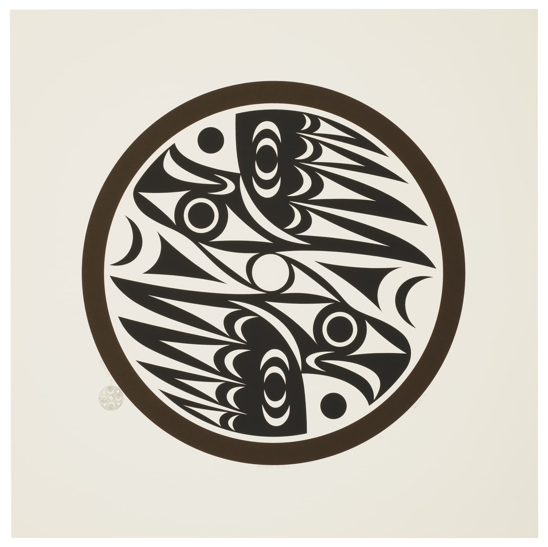 A circular design featuring intricate black abstract shapes and patterns against a cream background. The patterns include various curves and stylized forms, enclosed within a dark brown circular border. A small circular motif is located at the bottom left corner of the image.