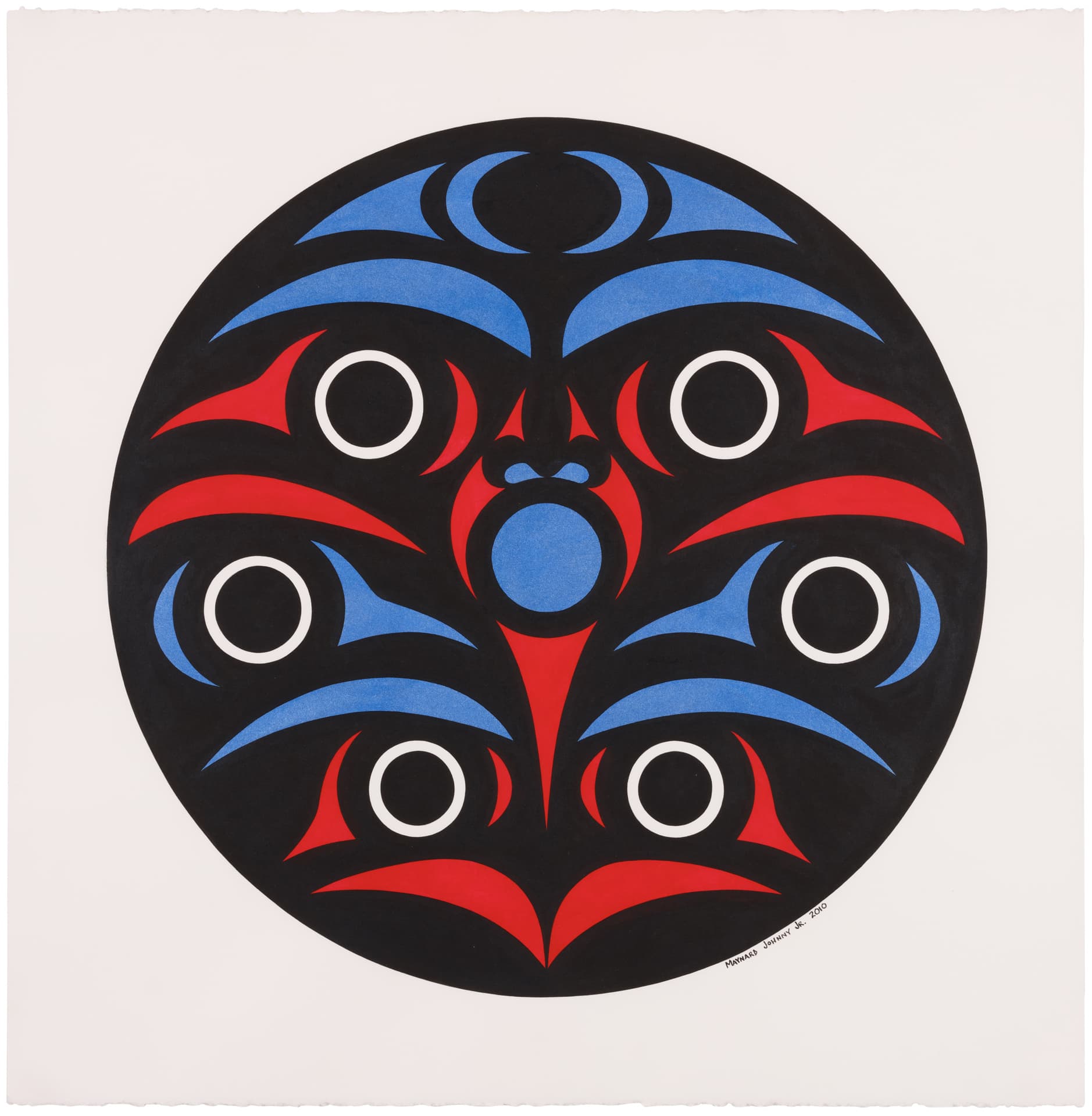 A circular artwork featuring a symmetrical design primarily in black, red, and blue. The composition includes stylized faces or masks, with wide eyes and curved shapes, creating a vibrant visual effect. The background is solid black, and the outer circle has white accents around the eyes. The artist's signature is visible in the lower right corner.